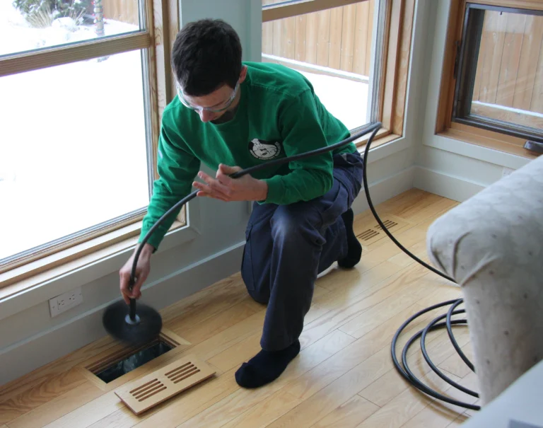 Gabriel putting brush system into a supply vent
